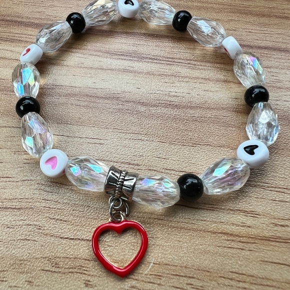 Beaded stretchy bracelet with clear acrylic beads, heart beads and charm - Picture 2 of 3